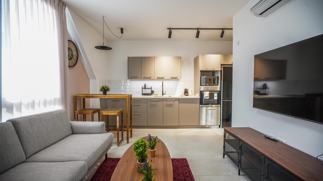סלון ומטבח בדירת Airbnb בתל אביב - עיצוב פנים סקנדינבי חמים מאת איריס פלס אזולאי